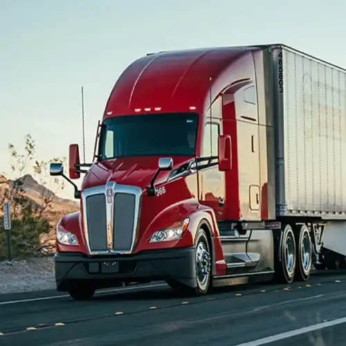 red dry van owner operator driving his truck happy with his dispatcher